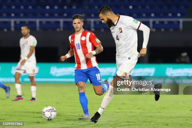 Jhon Chancellor of Venezuela kicks the ball against Luis Amarilla of Paraguay during a match between Paraguay and Venezuela as part of South American...