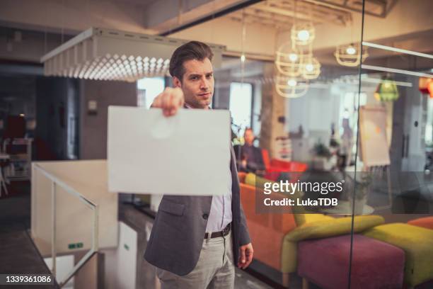 let's talk about: - office holding sign stockfoto's en -beelden