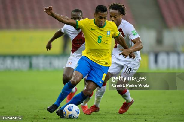 Alex Sandro of Brazil fights for the ball with André Carrillo of Peru during a match between Brazil and Peru as part of South American Qualifiers for...