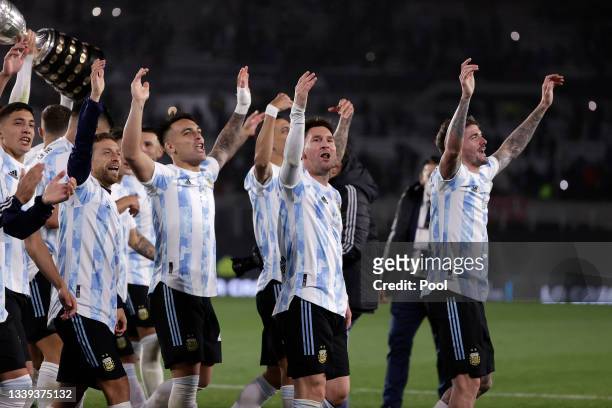 Lionel Messi of Argentina and teammate celebrate with the Copa America trophy after a match between Argentina and Bolivia as part of South American...