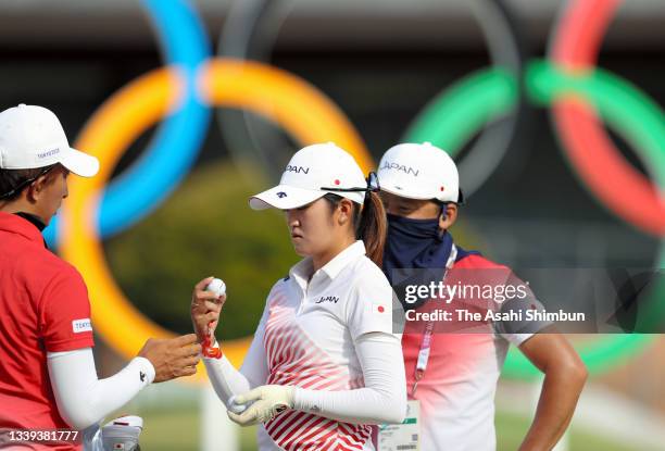 Mone Inami of Team Japan talks with staffs on the practice green prior to the final round of the Women's Individual Stroke Play on day fifteen of the...