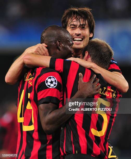 Manchester City's Italian forward Mario Balotelli celebrates with teammate Argentinian defender Pablo Zabaleta and French defender Gaël Clichy after...