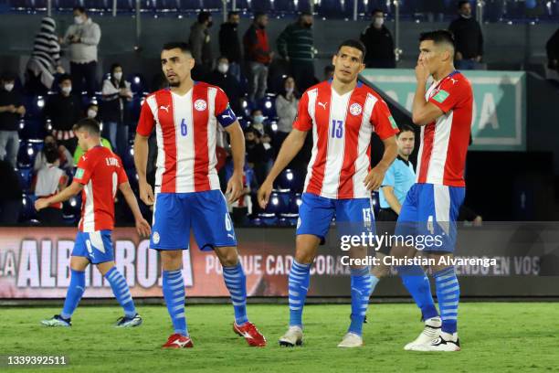 Junior Alonso, Marcos Cáceres and Fabian Balbuena of Paraguay react after a match between Paraguay and Venezuela as part of South American Qualifiers...