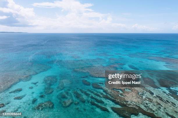 aerial view of blue tropical sea and fringing coral reef, okinawa, japan - miyakojima stock pictures, royalty-free photos & images