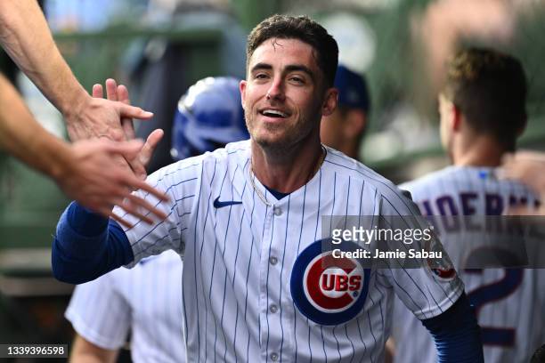 Cody Bellinger of the Chicago Cubs celebrates in the dugout after scoring a run in the second inning against the Philadelphia Phillies at Wrigley...