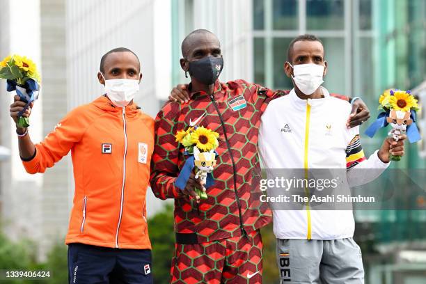 Silver medalist Abdi Nageeye of Team Netherlands, gold medalist Eliud Kipchoge of Team Kenya and bronze medalist Bashir Abdi of Team Belgium pose at...