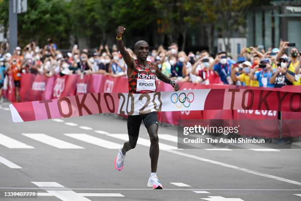 Eliud Kipchoge of Team Kenya crosses the finish line to win the gold medal after competing in the Men's Marathon on day sixteen of the Tokyo 2020...