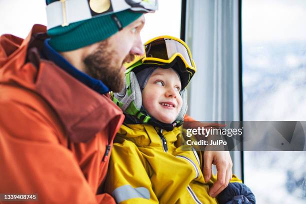 father with son in ski lift at ski resort - skidsemester bildbanksfoton och bilder