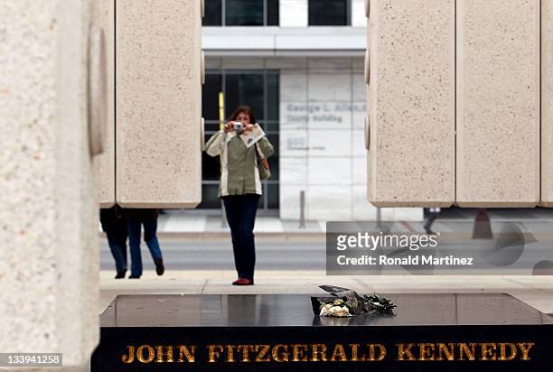 Person takes a photo of the empty tomb at the Kennedy Memorial Plaza on November 22, 2011 in Dallas, Texas. The 48th anniversary of the assassination...