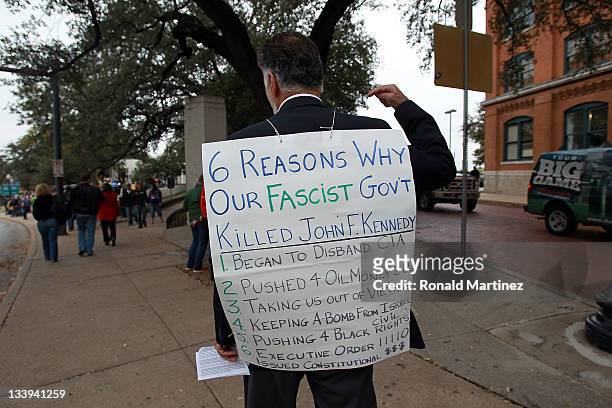 Richard Sheridan carries a sign on the 48th anniversary of JFK's assassination in Dealey Plaza on November 22, 2011 in Dallas, Texas. The 48th...