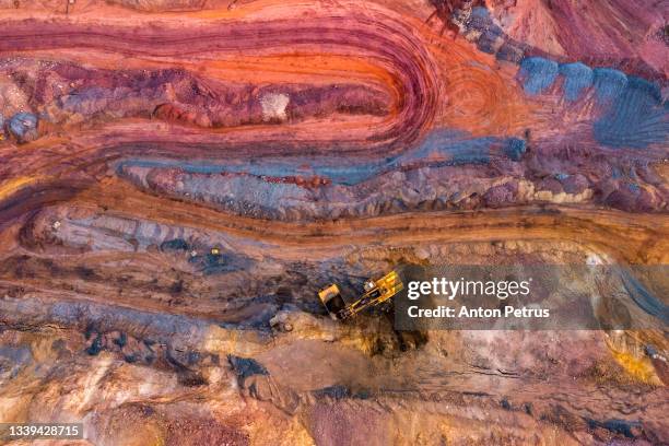 aerial view of open pit iron ore and heavy mining equipment. - copper mine stock pictures, royalty-free photos & images
