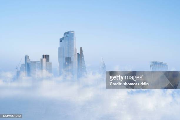 multi layered cityscape of london skyline emerging through clouds - wolkenkratzer stock-fotos und bilder