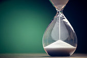 Hourglass time passing background concept for business deadline, urgency and running out of time