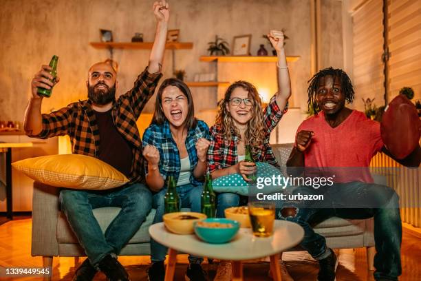 excited fans cheering for sport team watching american football game - home game sport stock pictures, royalty-free photos & images