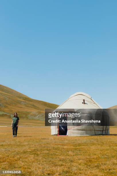 young smiling woman meets morning in the mountains from yurt camp in kyrgyzstan - bishkek stock pictures, royalty-free photos & images