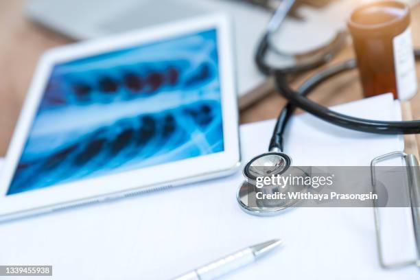 top view of medicine integrates advanced medical equipment and smartphones on the table is a medical concept. - medical research paper stock pictures, royalty-free photos & images