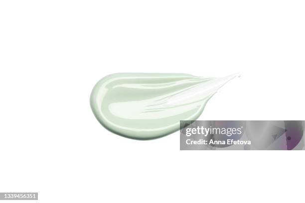 smooth cosmetic smear of pastel green cream isolated on white background. concept of health and wellbeing. flat lay style with copy space - green room stockfoto's en -beelden