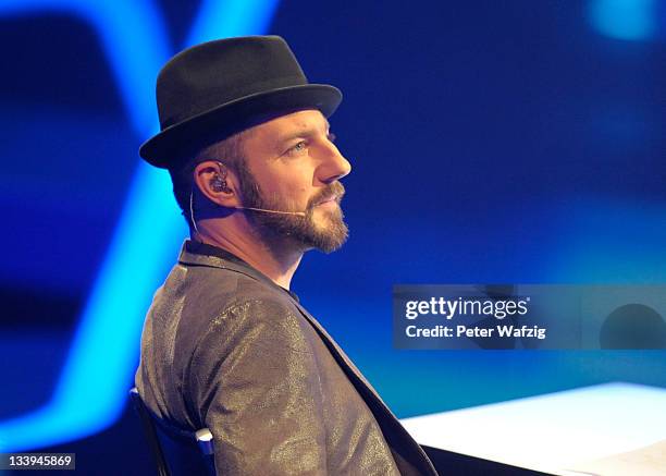 Jury member Mirko Bogojevic listens to a performance during 'The X Factor Live' TV-Show on November 22, 2011 in Cologne, Germany.
