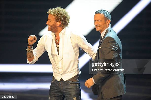 Rufus Martin celebrates together with jury member Till Broenner during 'The X Factor Live' TV-Show on November 22, 2011 in Cologne, Germany.
