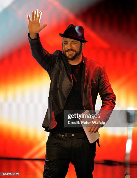 Jury member Mirko Bogojevic waves to the audience during 'The X Factor Live' TV-Show on November 22, 2011 in Cologne, Germany.