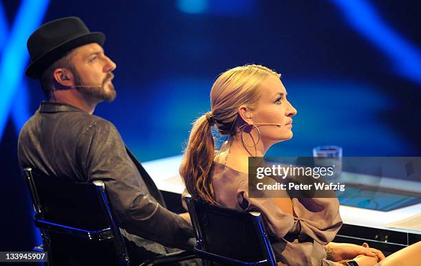Jury members Mirko Bogojevic and Sarah Connor listen to a performance during 'The X Factor Live' TV-Show on November 22, 2011 in Cologne, Germany.