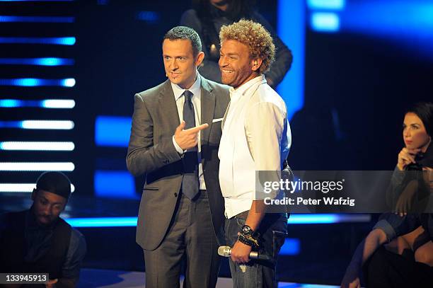 Jury member Till Broenner introduces his artist Rufus Martin during 'The X Factor Live' TV-Show on November 22, 2011 in Cologne, Germany.