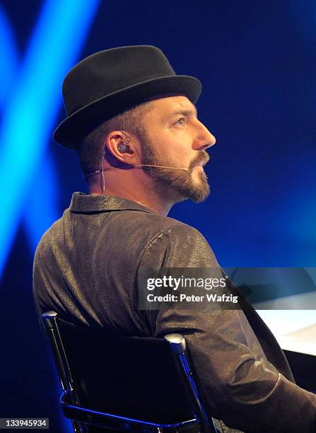 Jury member Mirko Bogojevic listens to a performance during 'The X Factor Live' TV-Show on November 22, 2011 in Cologne, Germany.