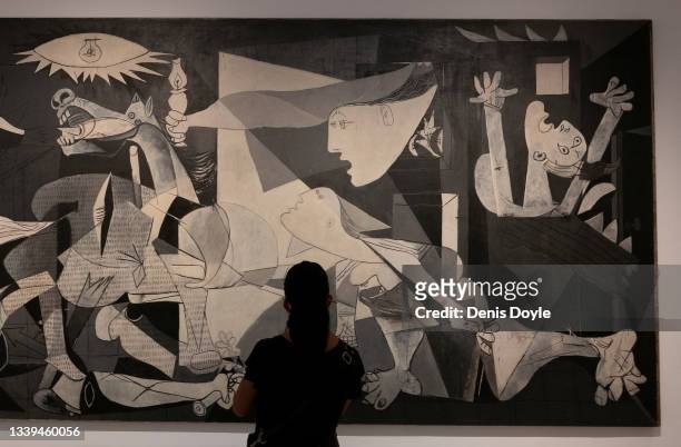 Woman views Pablo Picasso's Guernica painting at the Reina Sofia Museum during celebrations to mark the 40th anniversary of the arrival of the...