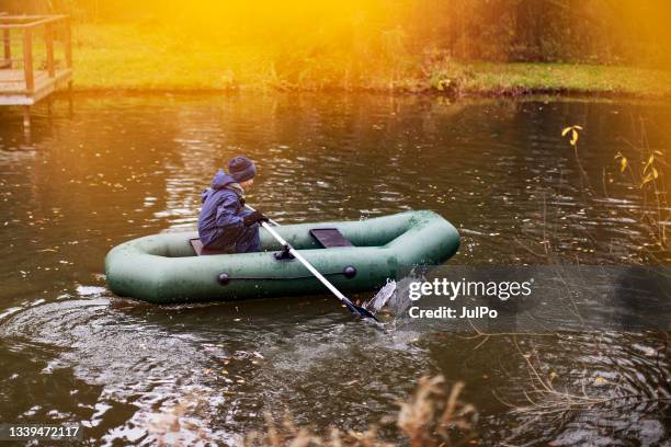 little boy in boat - rubber boat stock pictures, royalty-free photos & images