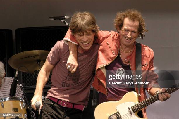 British Rock musicians Mick Jagger and Keith Richards, the latter on guitar, as they perform onstage, with their group the Rolling Stones, during a...