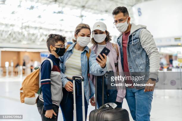 family taking a selfie at the airport before the flight - latin america covid stock pictures, royalty-free photos & images