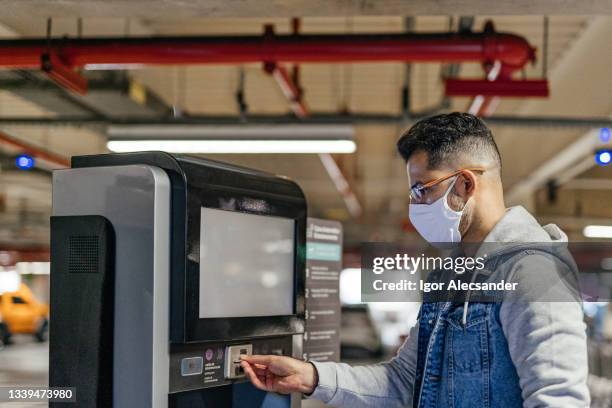 man at the parking payment counter - parking deck stock pictures, royalty-free photos & images