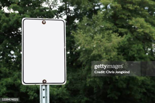 blank white sign on metal post in forest - metal sign stock pictures, royalty-free photos & images