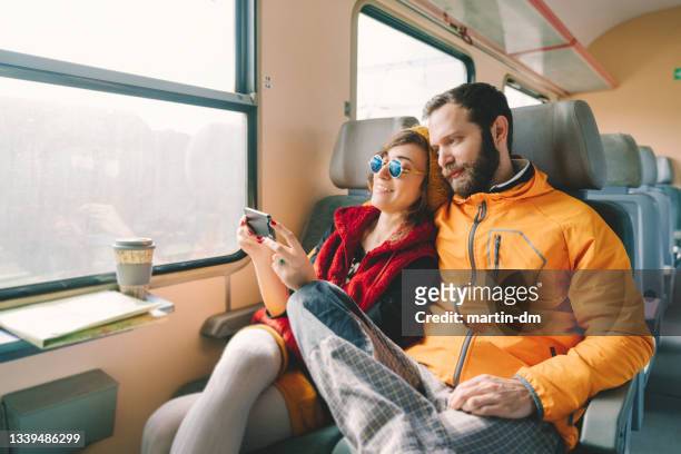 travelers - couple in a train stock pictures, royalty-free photos & images