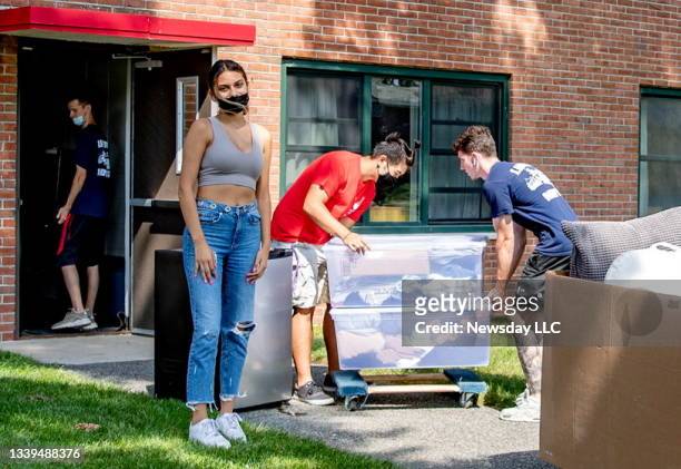 Leslie Amador, resident of the Ammann dorms at Stony Brook University in Stony Brook, New York, has her boxes carried away for relocation after...