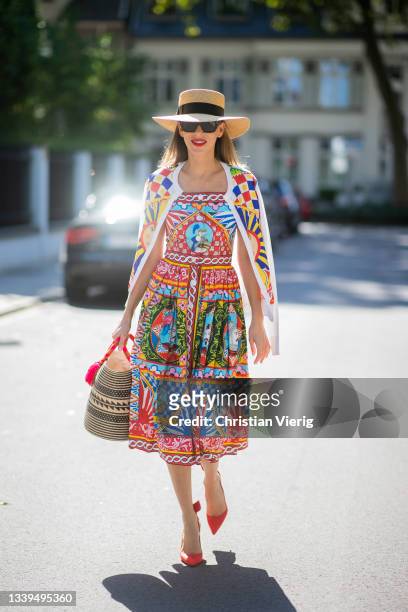 Alexandra Lapp is seen wearing Dolce & Gabbana dress, Gucci hat, bag Yosuzi, Louboutin heels in red on September 10, 2021 in Dusseldorf, Germany.