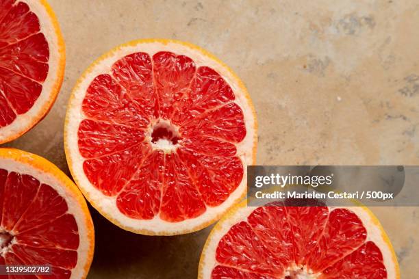 directly above shot of blood orange slices on table - grapefruit stock pictures, royalty-free photos & images