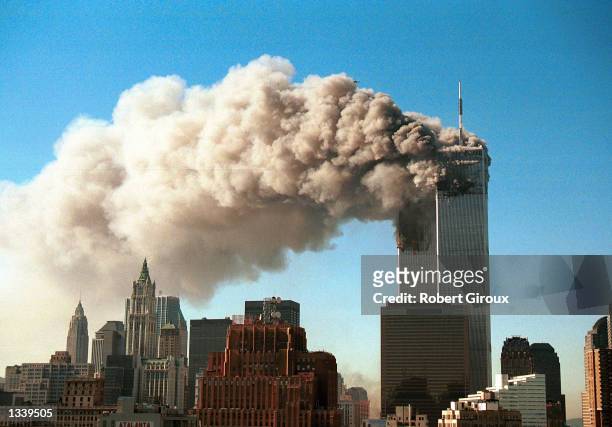 Smoke pours from the twin towers of the World Trade Center after they were hit by two hijacked airliners in a terrorist attack September 11, 2001 in...