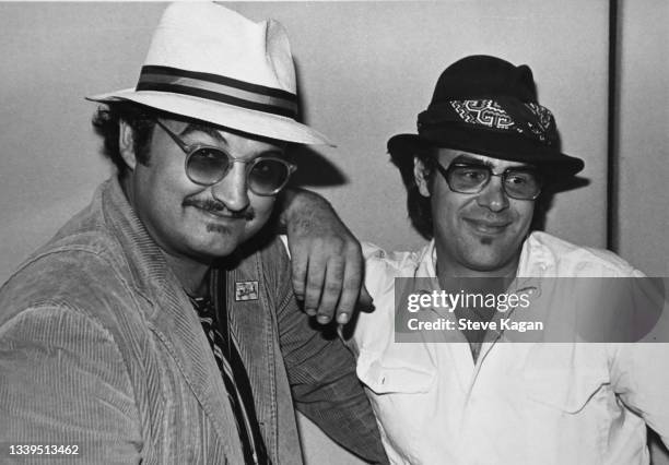 View of comedians and musicians John Belushi and Dan Aykroyd, as they promote the release of their film 'The Blues Brothers,' at an unspecified radio...