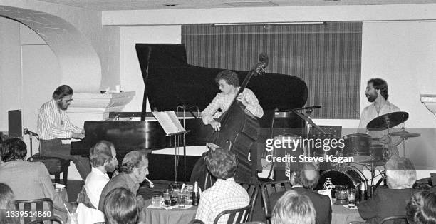 American Jazz musician Bill Evans , plays piano, as he performs with Trio, Marc Johnson , on bass, and Joe LaBarbera, on drums, at Rick's Cafe...