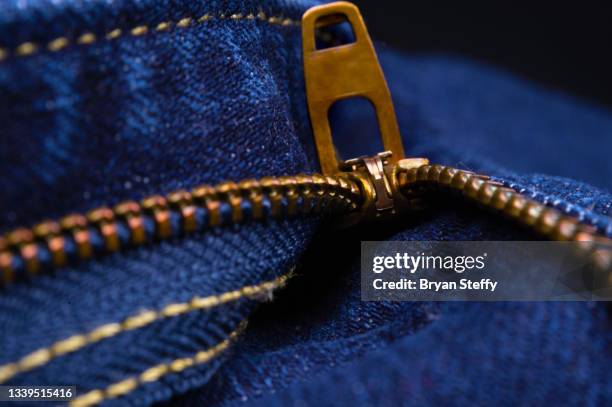 blue jeans unzipped zipper - fully unbuttoned stockfoto's en -beelden