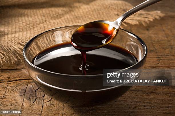 a spoonful of grape molasses - syrup stock pictures, royalty-free photos & images