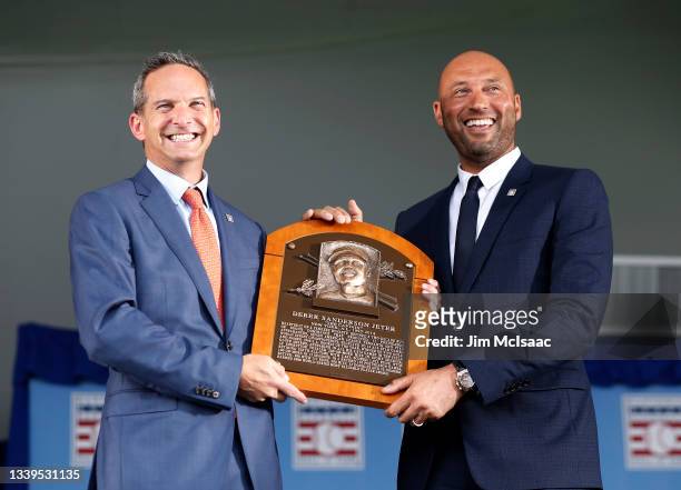 Derek Jeter accepts his plaque from interim Hall of Fame President Jeff Idelson during the Baseball Hall of Fame induction ceremony at Clark Sports...