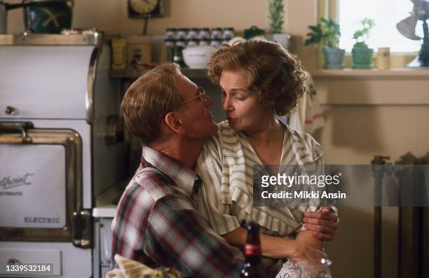 View of married American actors Joanne Woodward and Paul Newman in a kitchen, during the filming of 'Mr & Mrs Bridge' , Kansas City, Missouri,...