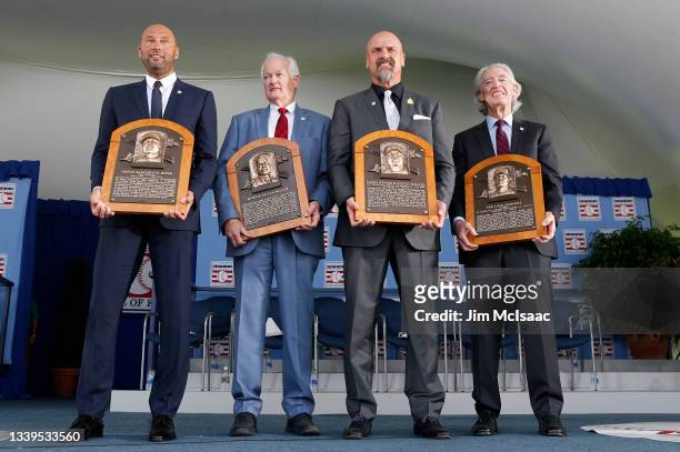 Derek Jeter, Don Fehr representing the late Marvin Miller, Larry Walker and Ted Simmons pose for a photograph with their plaques during the Baseball...