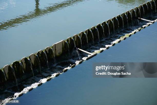 flow distribution trough and weir in sewage treatment - sewage treatment plant stock pictures, royalty-free photos & images
