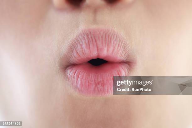 young woman's lip,close-up - mund stock-fotos und bilder