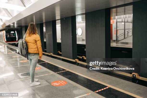 young woman waiting at subway station - toronto subway stock pictures, royalty-free photos & images