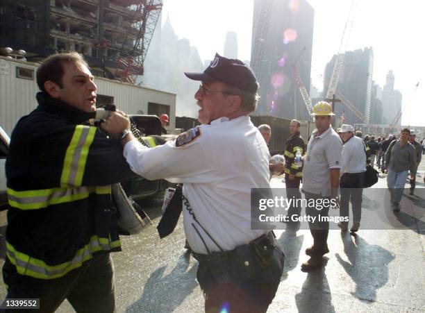 Firefighter is arrested during a rally near the collapse zone of the World Trade Center November 2, 2001 in New York City. Several hundred...