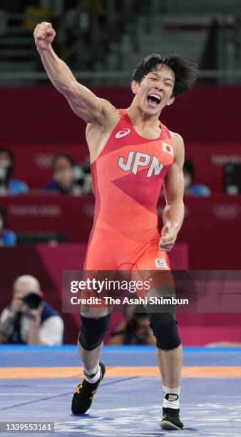 Takuto Otoguro of Team Japan celebrates winning the gold medal after his victory over Haji Aliyev of Team Azerbaijan in the Men's Freestyle 65kg...